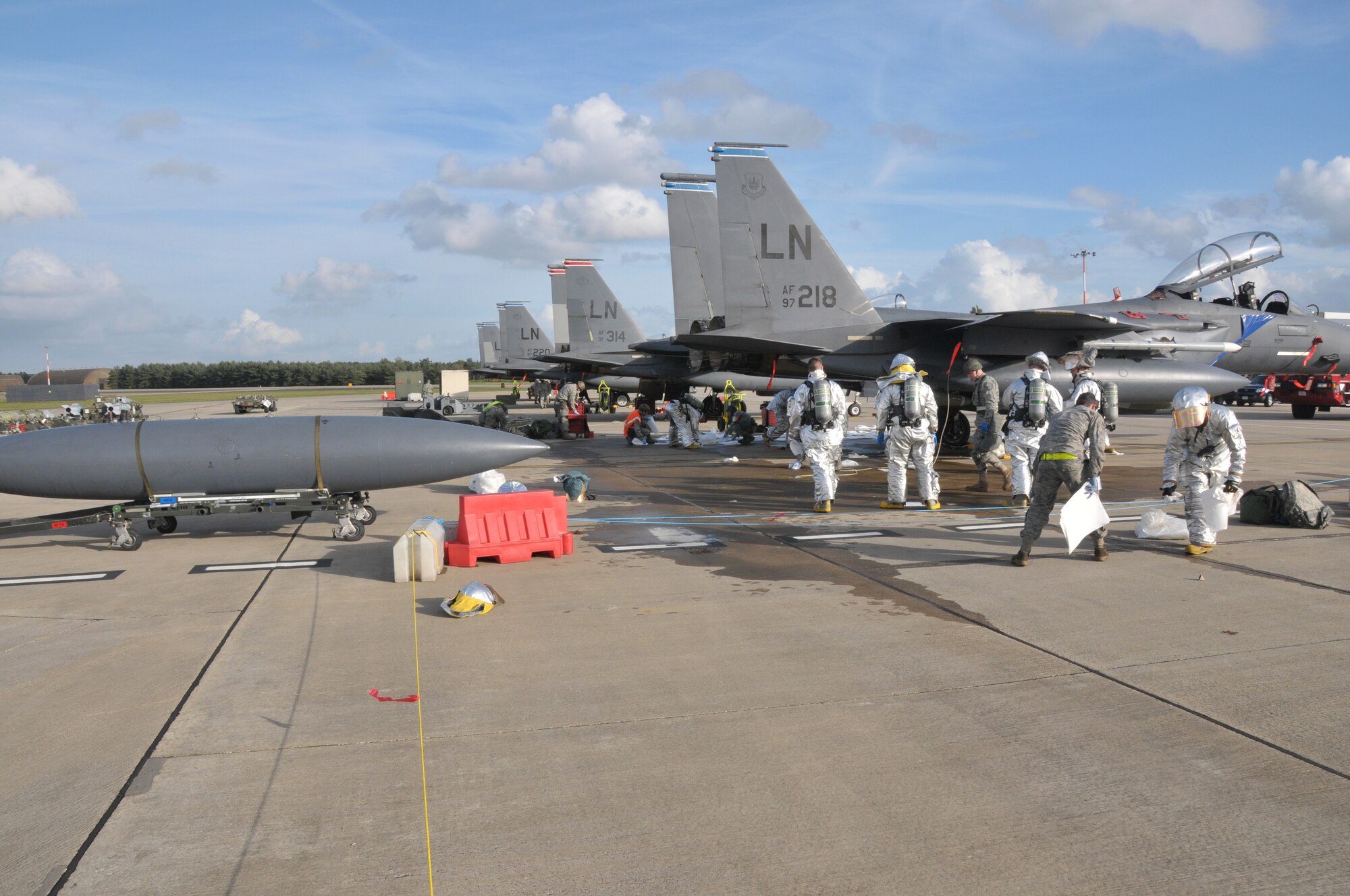 ROYAL AIR FORCE LAKENHEATH, England – Members of the 48th Civil Engineer Squadron fire department and 48th Aircraft Maintenance Squadron work together to clean up a fuel spill on the flight line during the Operational Readiness Inspection Oct. 27.  The ORI tested the wing’s preparedness to execute support combat operations worldwide.  (U.S. Air Force photo/Staff Sgt.  Connor Estes)