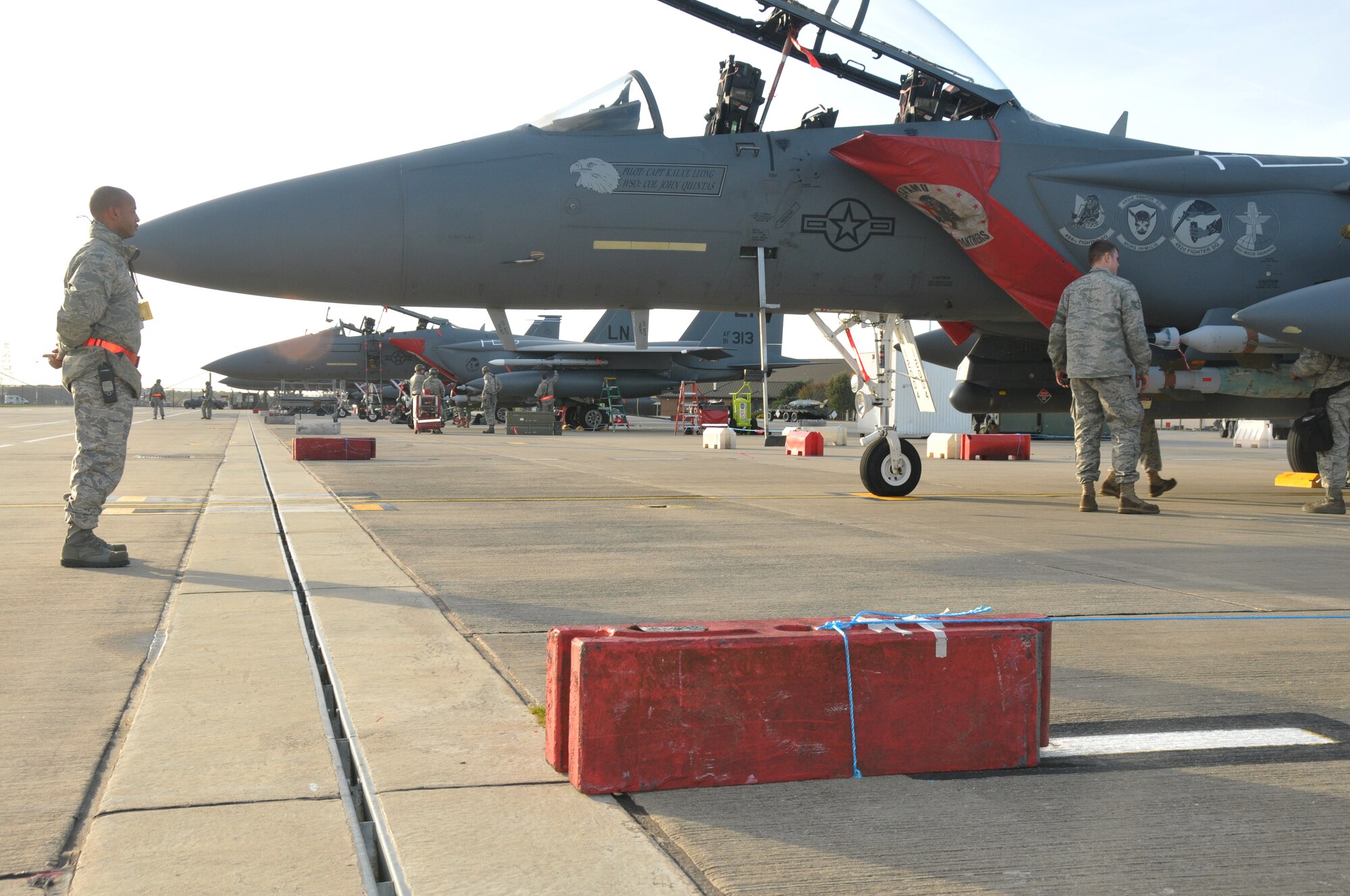 ROYAL AIR FORCE LAKENHEATH, England – A staff member of the inspector general team observes a weapons load team arming an F-15 during the operational readiness inspection Oct. 27.  From cargo and personnel movement to force protection condition implementation, the team of inspectors took a hard look at the suitability and capability of each of the players during the Phase 1 ORI.  (U.S. Air Force photo/Staff Sgt.  Connor Estes)
