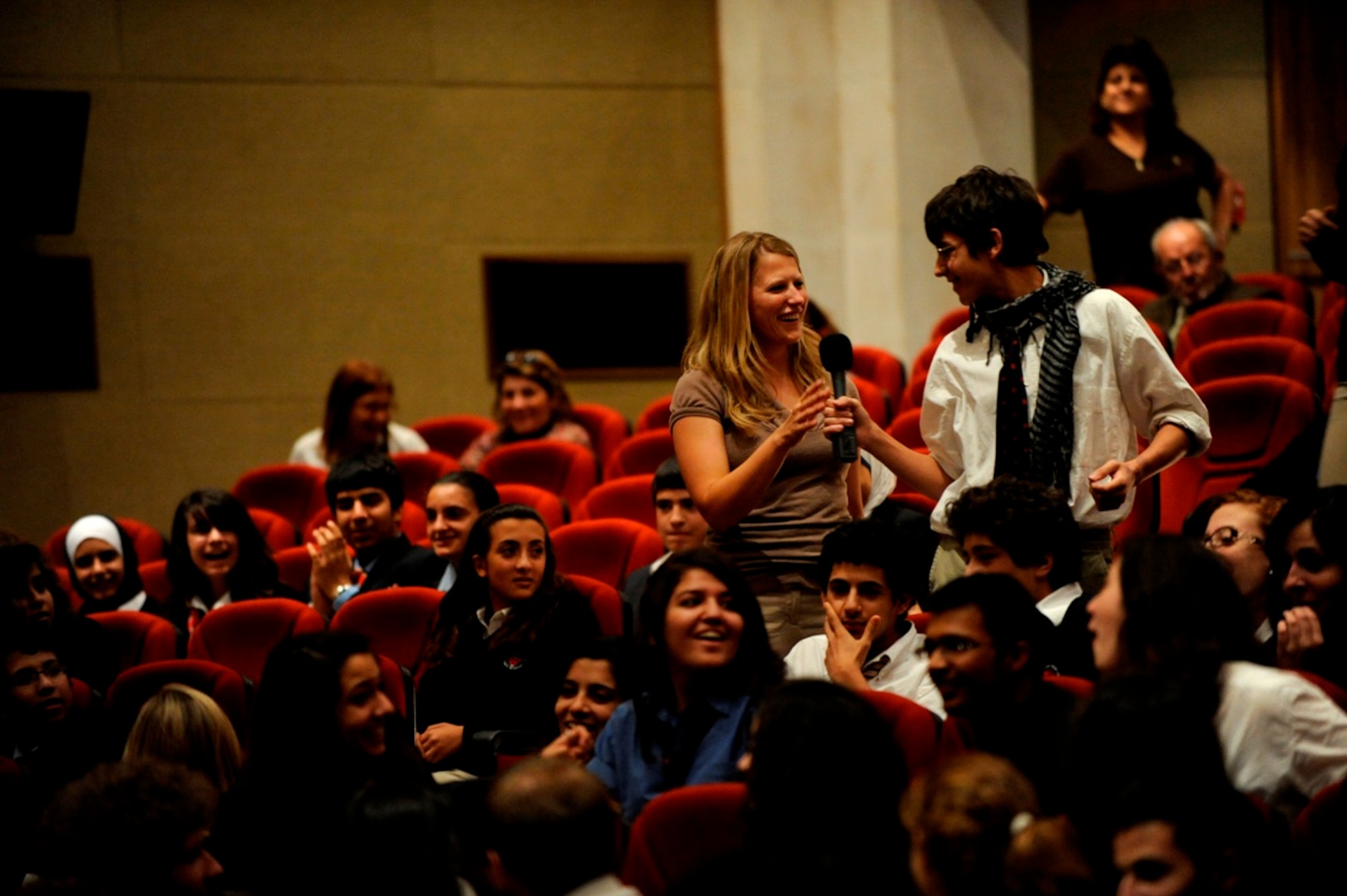 A student asks U.S. Air Force Airman 1st Class Megan Hokaj from U.S. Air Forces Central Band "Galaxy" a question during a performance at King's Academy in Madaba, Jordan, Oct. 27, 2010.  Galaxy performs for audiences throughout Southwest Asia to help build relations with international partners.  (U.S. Air Force Photo/Staff Sgt. Eric Harris)