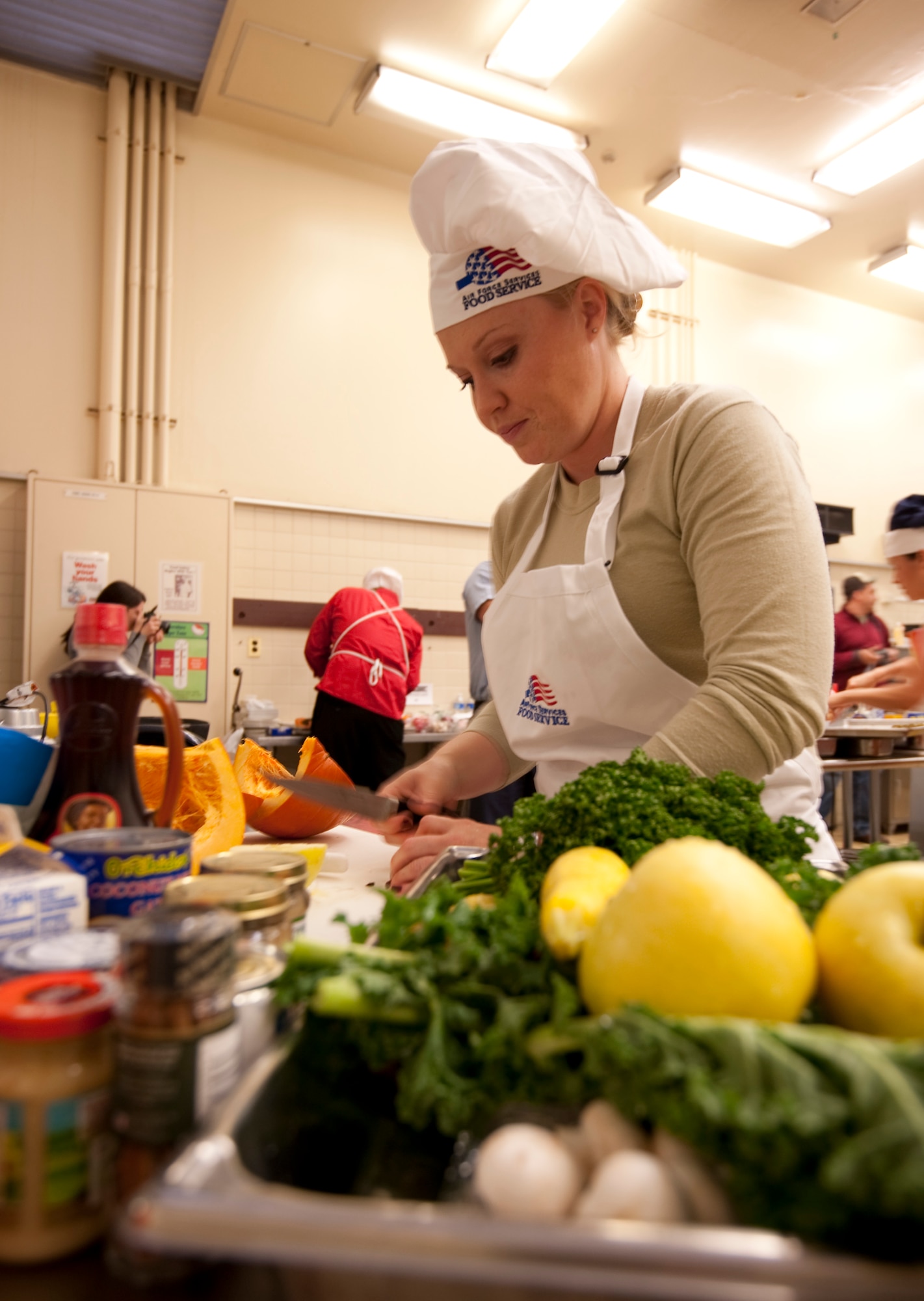 Staff Sgt. Sarah Marlow, 35th Judge Advocate Civil Law paralegal, dices pumpkin and vegetables for the second annual "Fit to Fight" Iron Chef competition, Oct. 27, 2010 at Misawa Air Base, Japan. Fresh pumpkin was the secret ingredient required to be used in all of the dishes. (U.S. Air Force photo by Airman James B. Bauer/Released)