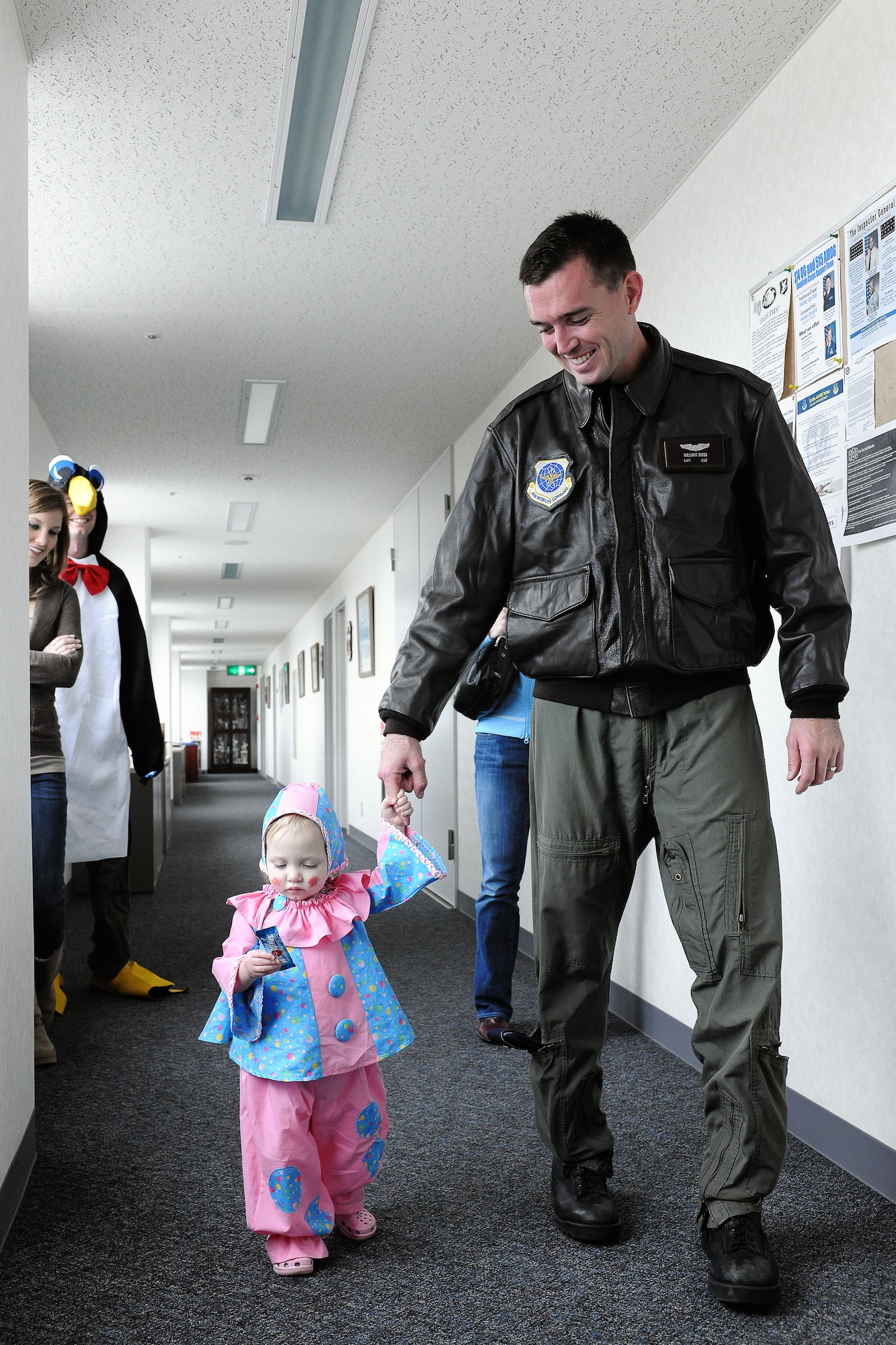 YOKOTA AIR BASE, Japan -- Capt William Dunn, 36th Airlift Squadron, takes his daughter, Ashley Dunn 17 months, trick-or-treating for the first time at the 374th Operations Group's 2nd Annual Family trick-or-treat. (U.S. Air Force photo/Osakabe Yasuo)