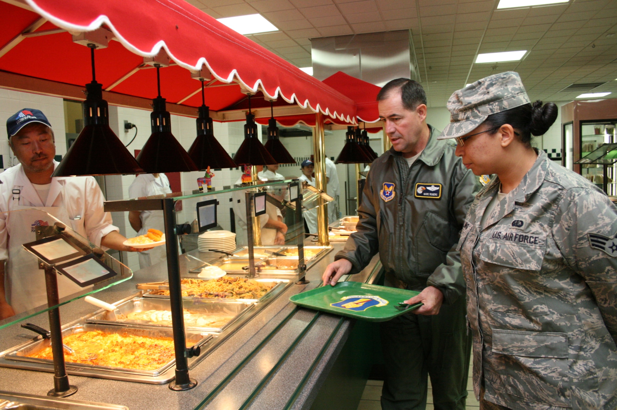 Senior Airman Lateasha Shilling, 35th Force Support facility storeroom clerk, showcases the Grissom Dining Facility to Lt. Gen. Marc Rogers, Inspector General of the Air Force, Office of the Secretary of the Air Force, Washington, D.C., Oct. 29, 2010, at Misawa Air Base, Japan. Following the tour, the general met with Airmen to discuss force-related issues. (U.S. Air Force photo by Capt. Darrick Lee/Released) 