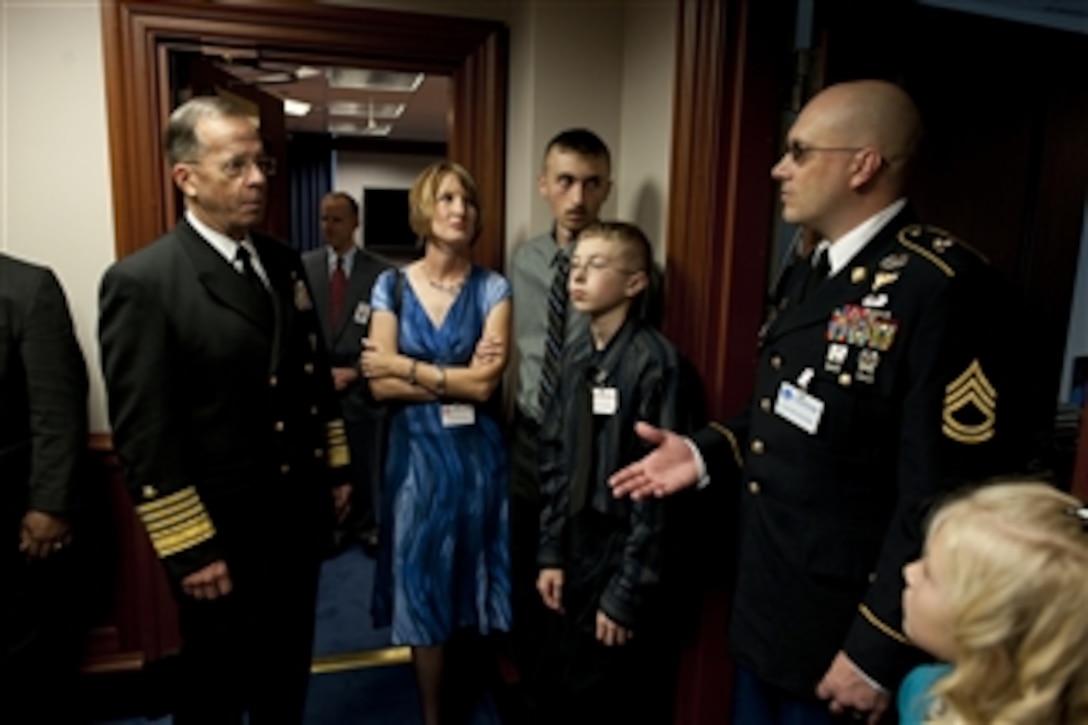 Chairman of the Joint Chiefs of Staff Adm. Mike Mullen, U.S. Navy, speaks with the family of U.S. Army Sgt. 1st Class William Frass at the premiere of the HBO documentary "Wartorn 1861-2010" in the Pentagon on Oct. 28, 2010.  Frass completed three tours of duty in Iraq as the leader of a reconnaissance unit and still struggles with stress related issues over two years later.  
