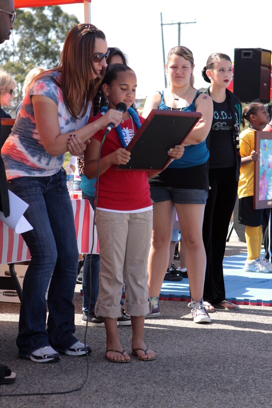Mya Russell, 8, read the Kids First Fair proclemation during the opening ceremony of the 17th annual Kids First Fair hosted by the Children, Youth and Teen Programs at the Paige Fieldhouse parking lot on Marine Corps Base Camp Pendleton April 28. The fair recognized children of military members and provided information and resources to service members and their families. Russell is a third grade student at Mary Fay Pendleton Elementary School.