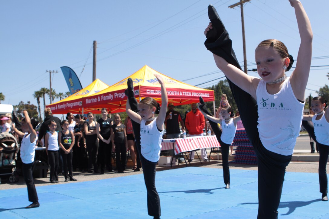 Dancers from the Oceanside Dance Academy perform a dance routine during the 17th annual Kids First Fair hosted by the Children, Youth and Teen Programs at the Paige Fieldhouse parking lot on Marine Corps Base Camp Pendleton April 28. Throughout the day, performers showcased skits and demonstrations for service members and their families at the fair.