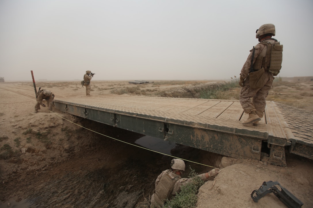 Marines with Bridge Platoon, Company A, 9th Engineer Support Battalion, 1st Marine Logistics Group (Forward), measure the distance from each bank while conducting an engineer reconnaissance mission in the Garmsir district, central Helmand province, Afghanistan, Oct. 29. The purpose of the recon mission was to gather information that will benefit the platoon when they conduct future bridge builds.