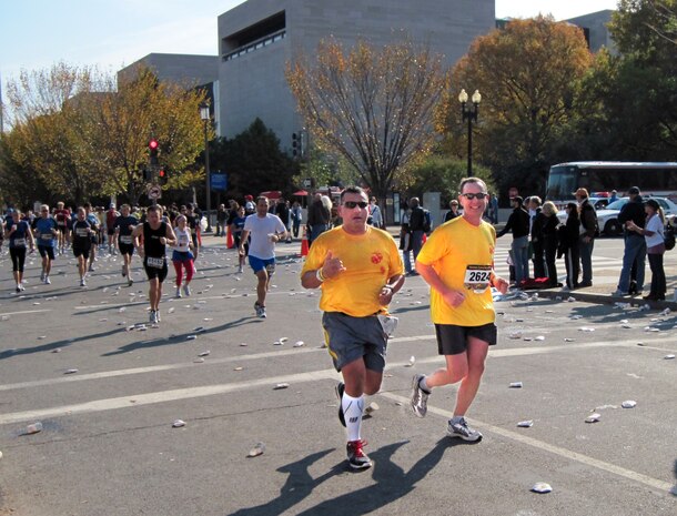 Gunnery Sergeant John Caraway (left), who works in Marine Corps Systems Command’s Communications, Intelligence and Networking Systems, runs alongside retired Lieutenant Colonel Bill Rysanek in the Marine Corps Marathon on Oct. 31. Caraway was diagnosed with cancer in April.