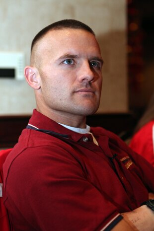 Capt. Richard Jennings, 34, sits and watches a promotional video of the 35th annual Marine Corps Marathon at the pasta dinner held Oct. 30, the night before the race. Jennings took part in his sixth Marine Corps Marathon the next day as a member of the All-Marine running team.