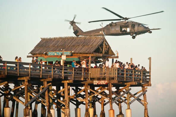 COCOA BEACH, Fla. - Pararescuemen from the 920th Rescue Wing at Patrick Air Force Base, Fla., fly by a crowd on the Cocoa Beach Pier in an HH-60G Pave Hawk during their water rescue demonstration at Air Force Week Cocoa Beach, Oct. 27, 2010. Air Force Week Cocoa Beach is a weeklong event showcasing U.S. Air Force capabilities to increase public awareness. (U.S. Air Force photo/Lance Cheung)
