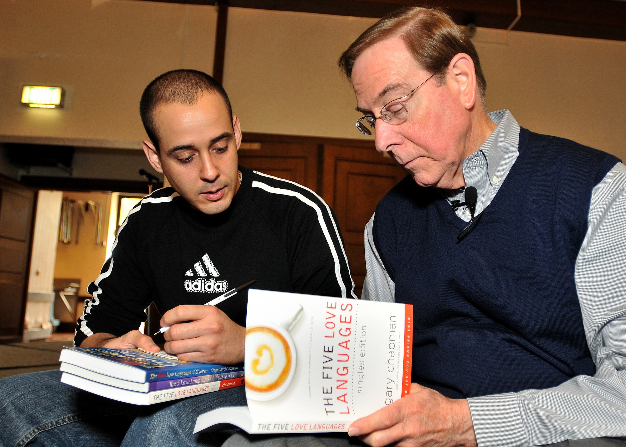 Dr. Gary Chapman, author of The Five Love Languages, signs a copy of his book for Tech. Sgt. Noel Sosa, 86th Contingency Aeromedical Staging Facility, during Dr. Chapman's marriage seminar at the Ramstein Officers Club Oct 30. (U.S. Air Force photo by Tech. Sgt. Markus M. Maier)