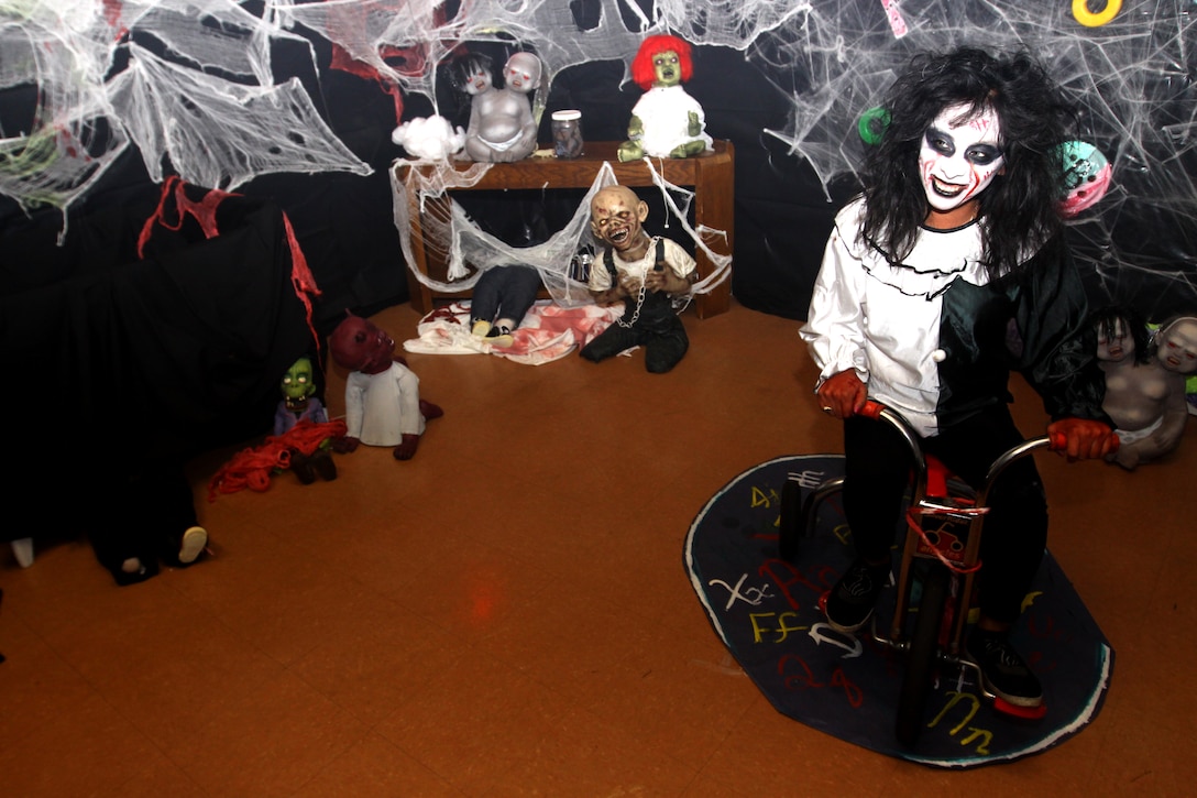 Adilene Rojas, program assistant, Wire Mountain Youth and Teen Center, Marine Corps Base Camp Pendleton, rides a tricycle during the base’s annual Haunted House of Horror at the Wire Mountain YTC, Oct 30. The House of Horror featured 13 different thrilling themes and was open for three nights.