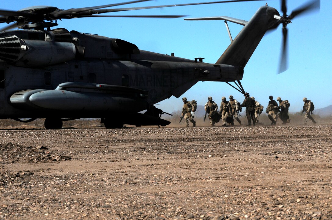 Marines with E Company, 2nd Battalion, 7th Marine Regiment, board a CH-53E Super Stallion during the final exercise of the recent Weapons and Tactics Instructor course at Auxiliary Airfield 6 on the Barry M. Goldwater Range in Ariz., Oct. 30, 2010. Operation War Wagon, tested the skills learned by the WTI students and included the participation of approximately 250 infantry Marines from the battalion.::r::::n::