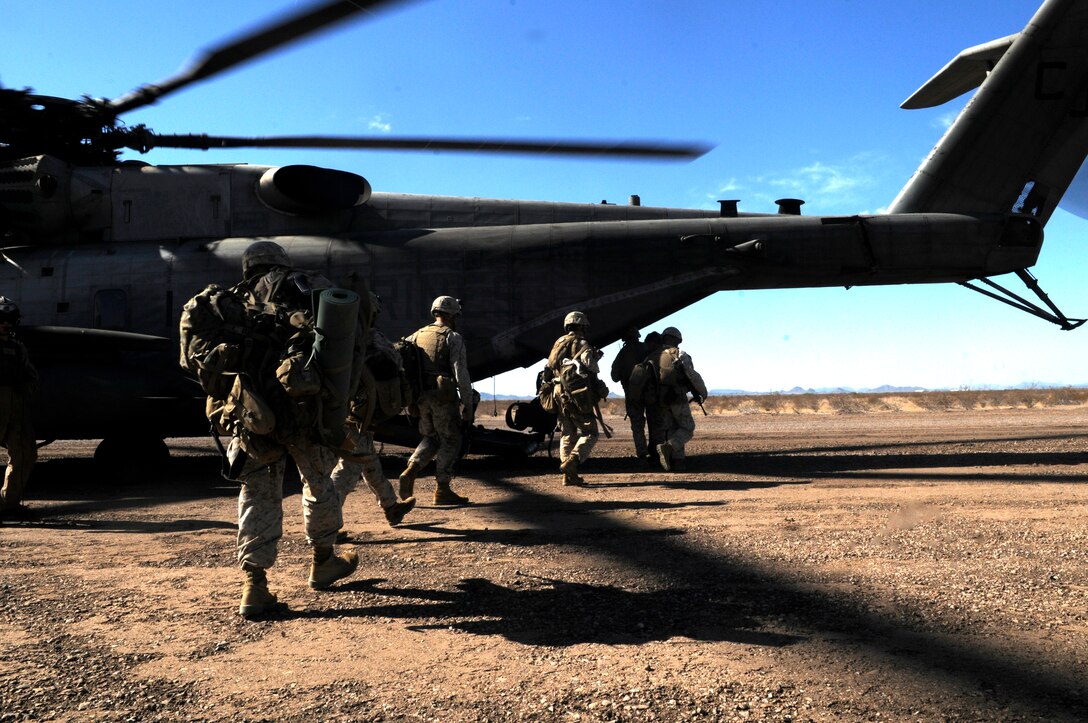 Marines with E Company, 2nd Battalion, 7th Marine Regiment, board a CH-53E Super Stallion during the final exercise of the recent Weapons and Tactics Instructor course at Auxiliary Airfield 6 on the Barry M. Goldwater Range in Ariz., Oct. 30, 2010. Operation War Wagon tested the skills learned by the WTI students and included the participation of approximately 250 infantry Marines from the battalion. ::r::::n::::r::::n::