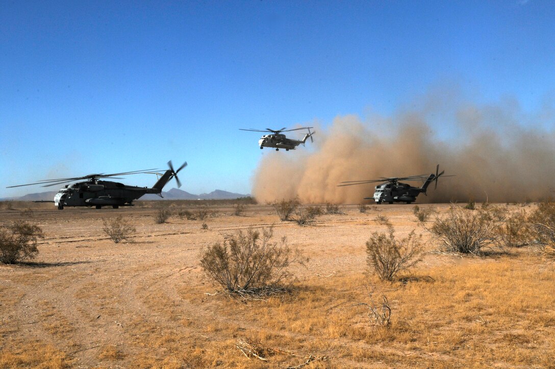 A CH-53D Sea Stallion takes off while two CH-53E Super Stallions prepare to do the same during the final exercise of the recent Weapons and Tactics Instructor Course at Auxiliary Airfield 6 on the Barry M. Goldwater Range in Ariz., Oct. 30, 2010. Operation War Wagon, tested the skills learned by the WTI students and included the participation of approximately 250 infantry Marines from the battalion.