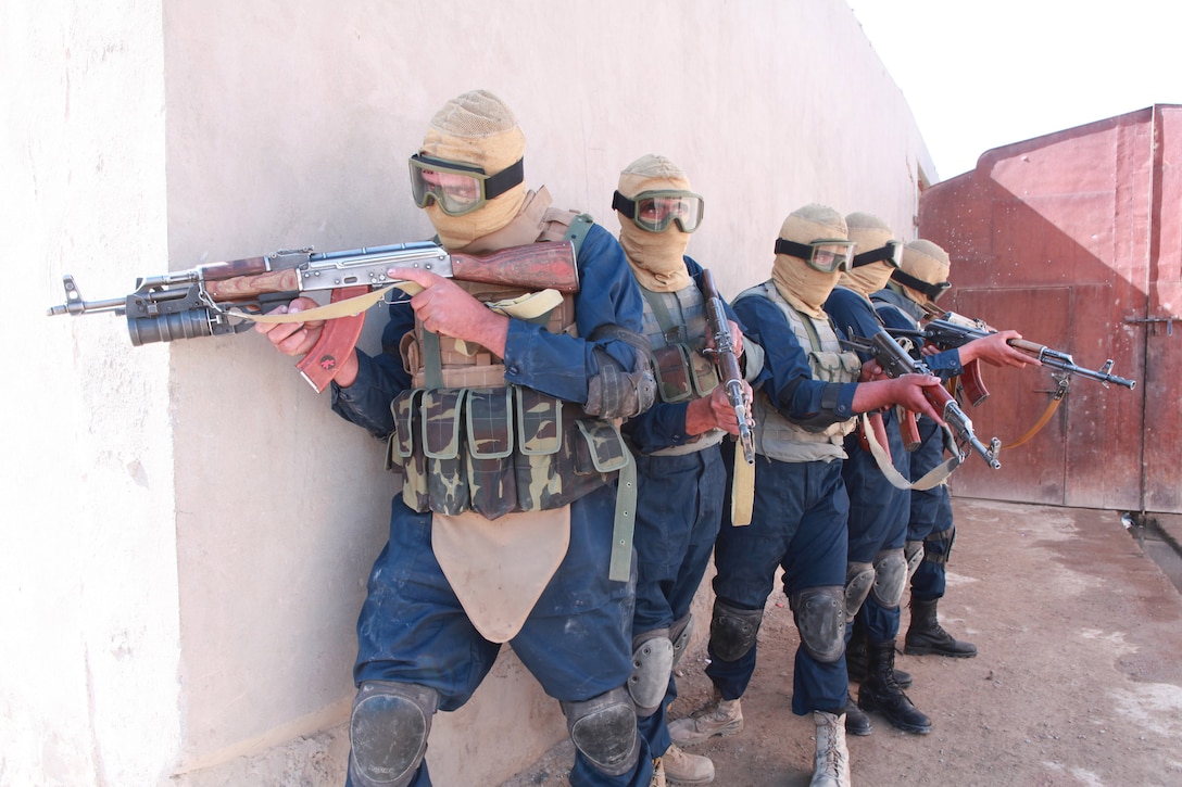 Members of the Afghan Uniform Police, who comprise the Musa Qal’eh commando police unit, rehearse tactical maneuvers, aboard the AUP compound in Musa Qal'eh, Oct. 31. With help from the Marines of 1st Battalion, 8th Marines, Regimental Combat Team 2, this elite police unit, is standing up to serve as a quick reaction force in the fight against the Taliban.::r::::n::