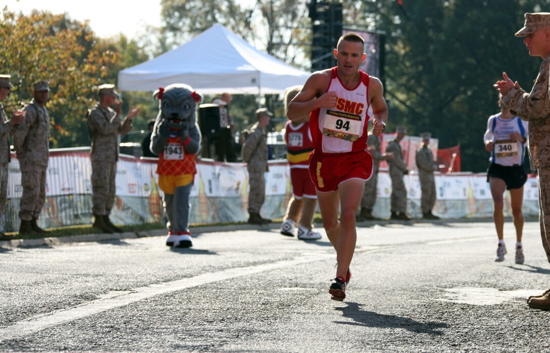 Capt. Richard Jennings approaches the finish line of the 35th annual Marine Corps Marathon Oct. 31, 2010. Jennings helped the U.S. Marine running team defeat the Royal British Marines and Navy team in the Challenge Cup by running his personal best time of 2 hours, 36 minutes and 20 seconds. The Challenge Cup has existed for more than 30 years and pits the top three finishers from each team against each other by combining their times. The team with the lowest total wins the cup.