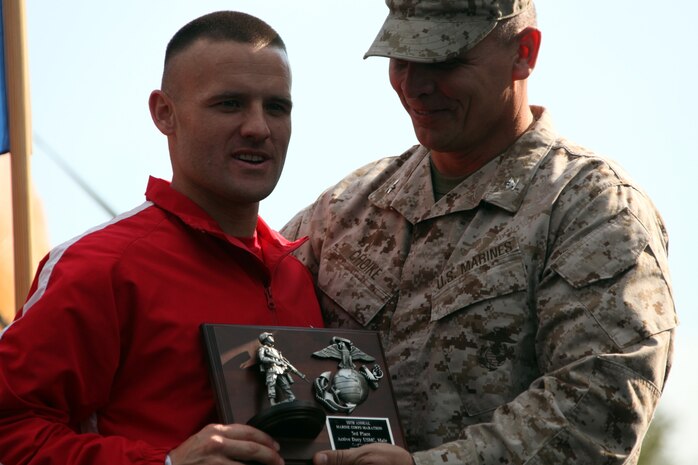 Capt. Richard Jennings receives his plaque for being the third place active duty Marine finisher from Col. Daniel Choike, Marine Corps Base Quantico, Va., commander Oct. 31, 2010. Jennings set a personal best time at the 35th annual Marine Corps Marathon finishing at 2 hours, 36 minutes and 20 seconds. "Today everything went well,” Jennings said.