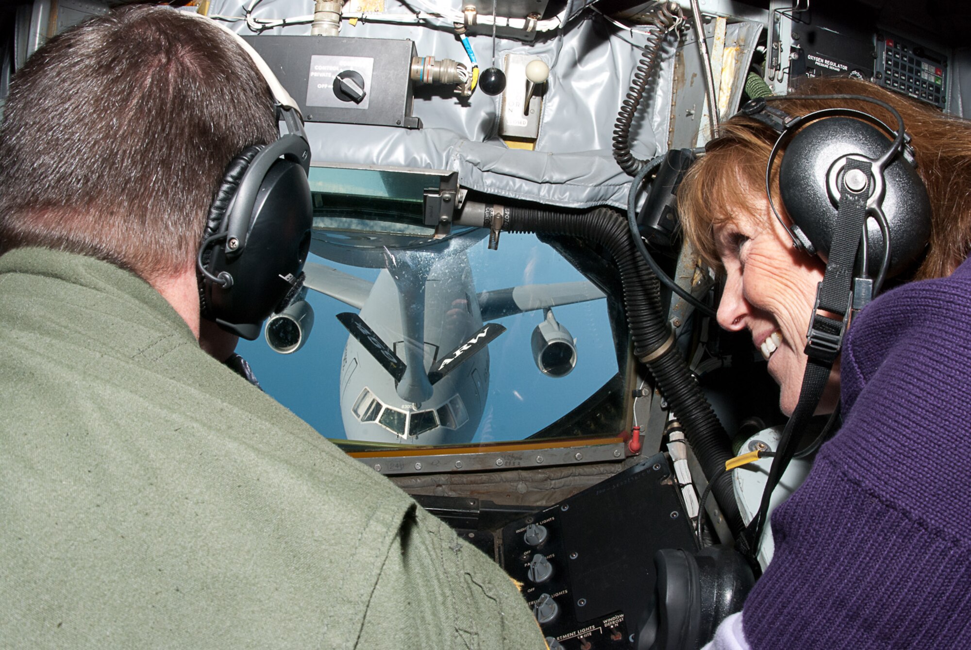 JOINT BASE ANDREWS, Md. –- In the boom operator compartment of a KC-135 Stratotanker, Maryland employer, Joni Forman, observes Senior Airman Matthew Oberlin, 756th Air Refueling Squadron, refuel a C-5  Globemaster III during an aerial refueling mission here Oct. 27. The mission was part of a bosslift sponsored by the Maryland Employer Support for the Guard and Reserve. (U.S. Air Force photo/Staff Sgt. Sophia Piellusch)