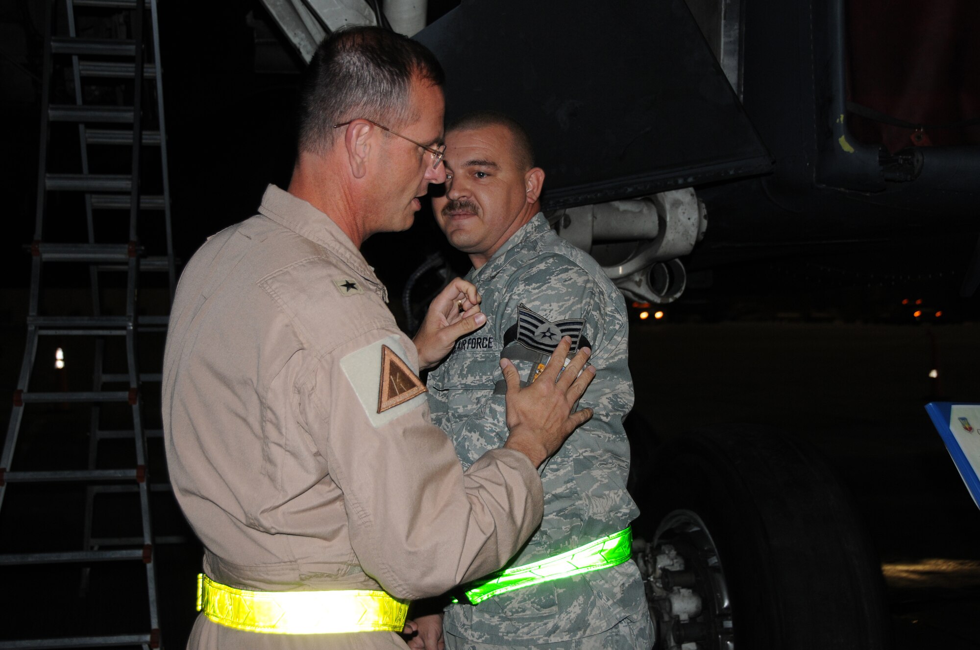 SOUTHWEST ASIA - Brig. Gen. Randy Kee, 379th Air Expeditionary Wing Commander, awards Staff Sgt. Jeremy Sherwood, Aircraft Fuel Systems Craftsman, a STEP promotion to Tech. Sgt. here Oct. 29. The Stripes for Exceptional Performers program recognizes outstanding individuals by promoting them instantly. Sergeant Sherwood's home unit is the 7th Component Maintenance Squadron from Dyess Air Force Base, Texas and is currently deployed with the 379th Expeditionary Maintenance Squadron. (U.S. Air Force photo/Tech. Sgt. Kimberly Spinner)