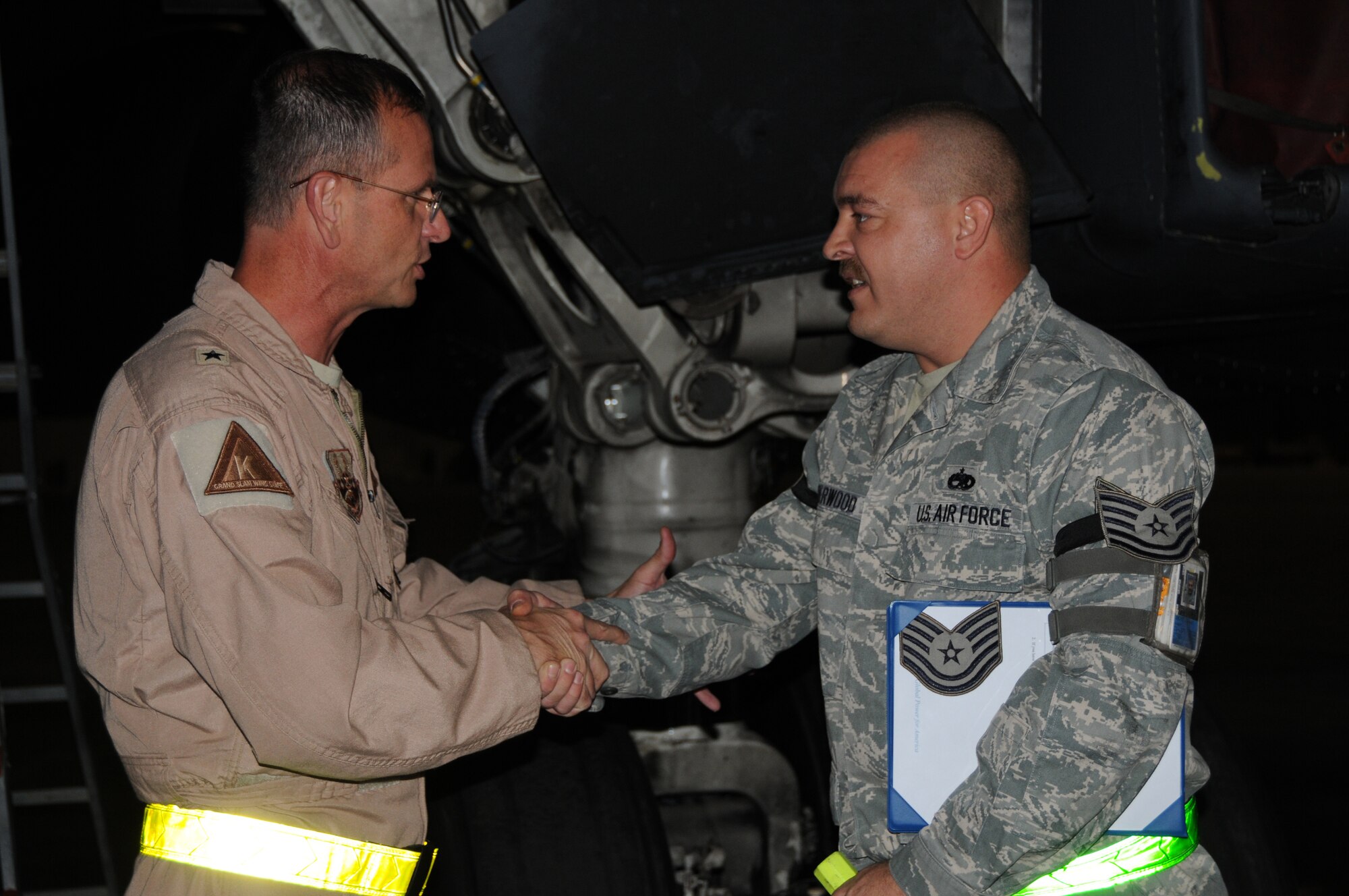 SOUTHWEST ASIA - Brig. Gen. Randy Kee, 379th Air Expeditionary Wing Commander, awards Staff Sgt. Jeremy Sherwood, Aircraft Fuel Systems Craftsman, a STEP promotion to Tech. Sgt. here Oct. 29. The Stripes for Exceptional Performers program recognizes outstanding individuals by promoting them instantly. Sergeant Sherwood's home unit is the 7th Component Maintenance Squadron from Dyess Air Force Base, Texas and is currently deployed with the 379th Expeditionary Maintenance Squadron. (U.S. Air Force photo/Tech. Sgt. Kimberly Spinner)