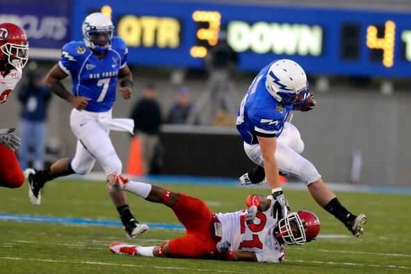Senior running back Nathan Walker leaps over a Utah defender during the first quarter of play against Utah at Falcon Stadium Oct 30, 2010. Walker had six carries for 31 yards in the Falcons' 28-23 loss to the No. 8 Utes. (U.S. Air Force photo/Johnny Wilson)