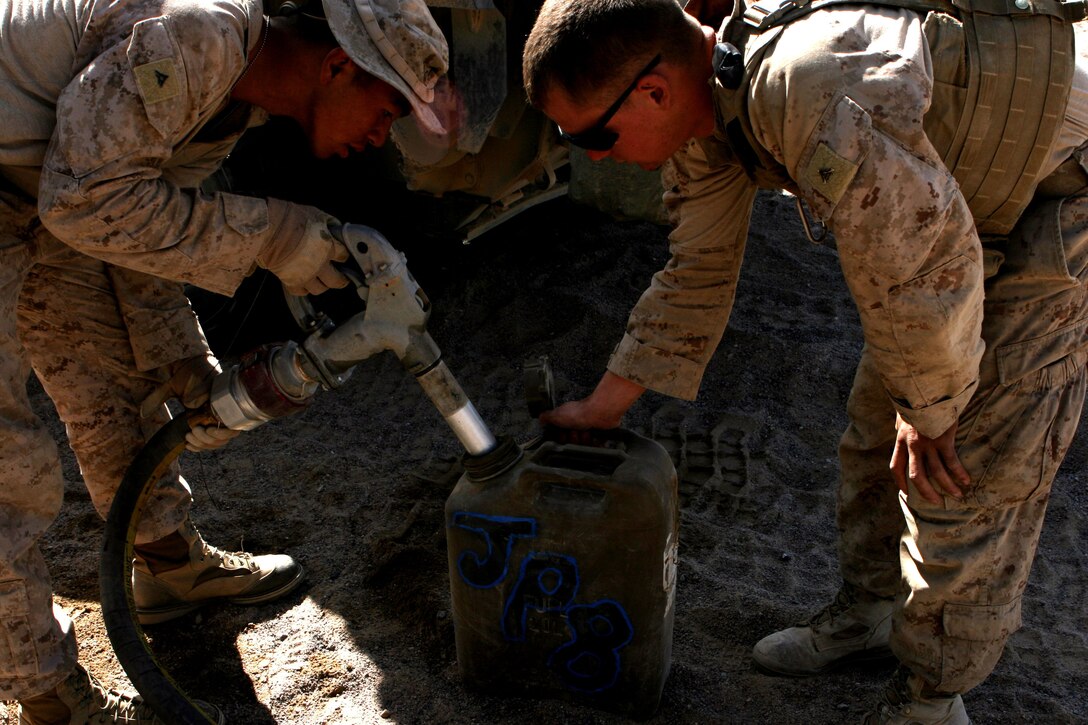Lance Cpl. Dade Huang, 21, a motor transport operator with Motor Transport Company A, Combat Logistics Battalion 3, 1st Marine Logistics Group (Forward), refuels a gas can for Marines of 1st Light Armored Reconnaissance Battalion at a forward landing support area in support of Operation Steel Dawn, Oct. 29. The LSA was used to resupply and refuel 1st LAR during the operation.