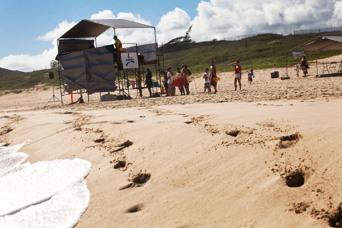 Marine Corps Community Services Aquatics employees help surfers check into the Kuau Rockin’ Surf Competition at Pyramid Rock Beach on Marine Corps Base Hawaii, Oct 31, 2010. While the event was originally scheduled for Oct. 9, MCCS organizers waited nearly a month to hold the competition during better wave conditions.