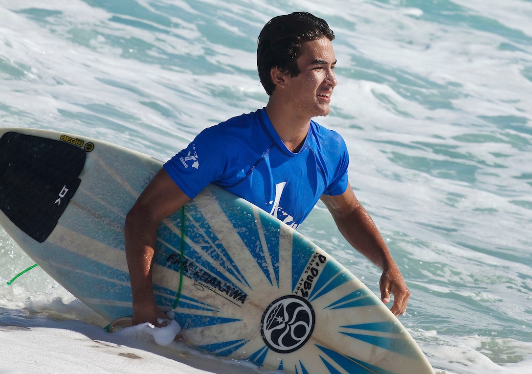 Sixteen-year-old competitor Justin Burbage emerges from the water after surfing a heat in the Kuau Rockin’ Surf Competition at Pyramid Rock Beach on Marine Corps Base Hawaii, Oct. 31, 2010. “It’s cool to have a chill surf session with the guys that are out there putting their lives on the line for our country,” said Burbage, of Kaneohe, Hawaii.