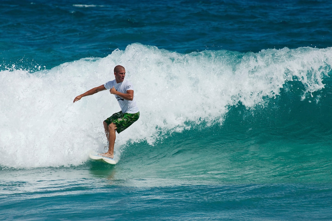 Joshua Behrens prepares to catch a wave during the men’s long board finals at the Kuau Rockin’ Surf Competition at Pyramid Rock Beach on Marine Corps Base Hawaii, Oct. 31, 2010. “Being on base helps civilians understand and appreciate the sacrifices service members make,” said Billy Domingo, founder of Ainoskedu, a local sports apparel brand and competition sponsor. “Without the military, we wouldn’t be able to surf in these waters.”