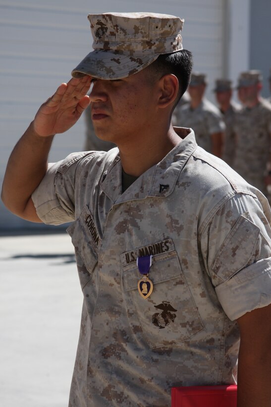 Lance Cpl. Tiofilo Corona Jr., a Marine with the 3rd Combat Engineer Battalion salutes after receiving a Purple Heart Wednesday at the 3rd CEB command section. Corona’s vehicle was hit with an improvised explosive device last May in Afghanistan.
