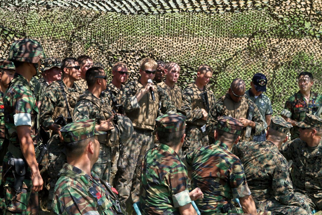 Lance Cpl. Thomas Turner, Motor Transport Company, Combat Logistics Battalion 4, Combat Logistics Regiment 3, 3rd Marine Logistics Group, III Marine Expeditionary Force, asks the Republic of Korea Marine commanders questions about standard operating procedures during an after-action convoy review.