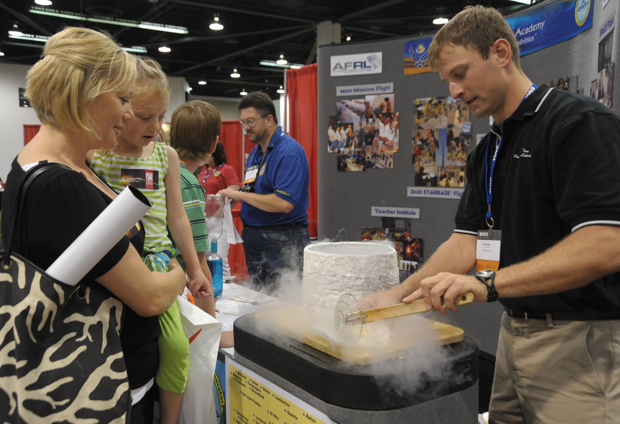 A staffer from the Air Force Research Laboratory demonstrates  a science experiment freezing items in liquid nitrogen in Education Alley at the AIAA Space 2010 conference, Sept.1.  Staff from various government agencies and industry partners demonstrated science and space exploration to students visiting the conference. (Photo by Joe Juarez)