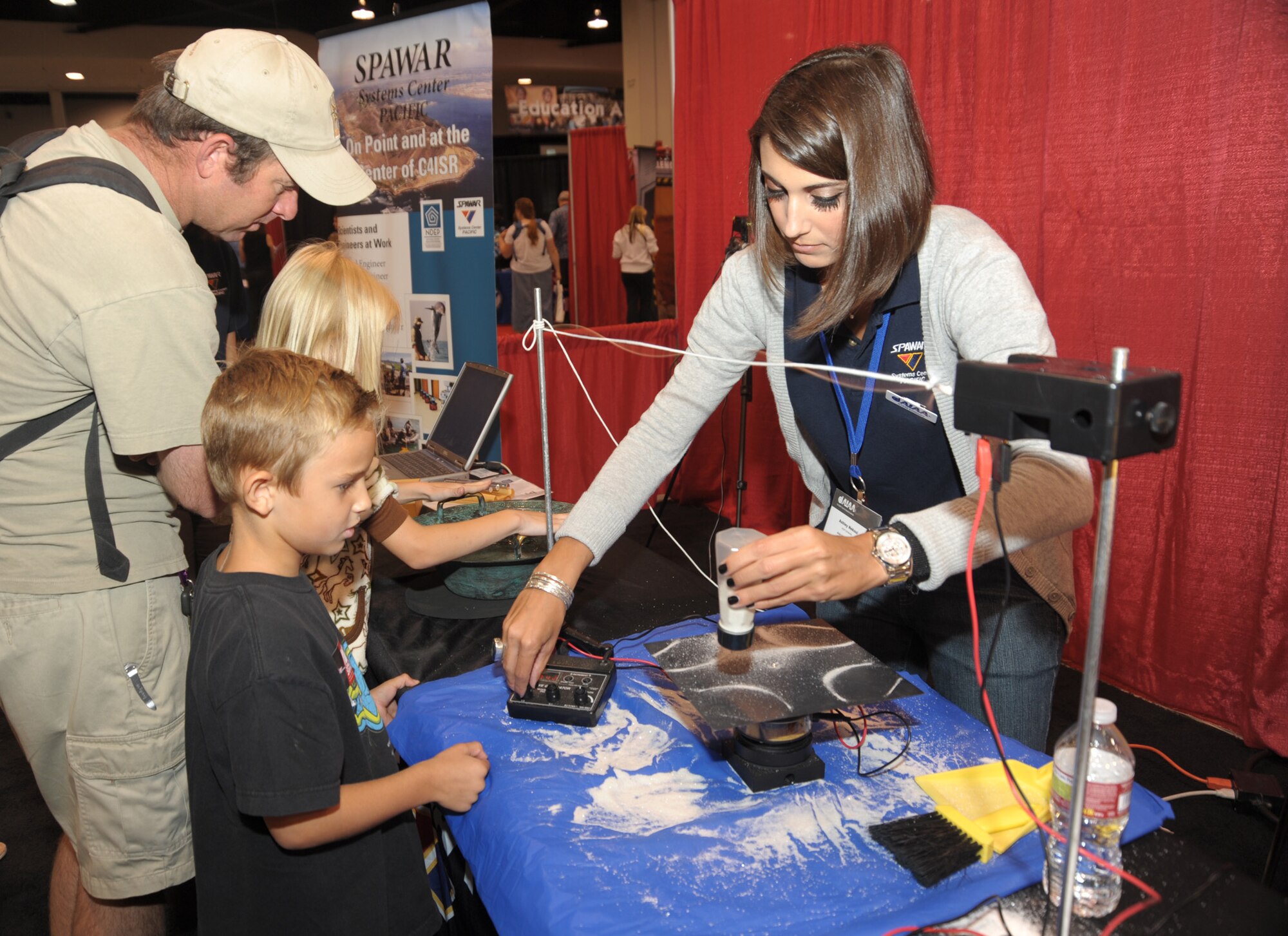 A staffer from the Navy’s SPAWAR office performs a science project in Education Alley at the AIAA Space 2010 conference, Sept.1.   Staff from various government agencies and industry partners demonstrated science and space exploration to students visiting the conference. (Photo by Joe Juarez)