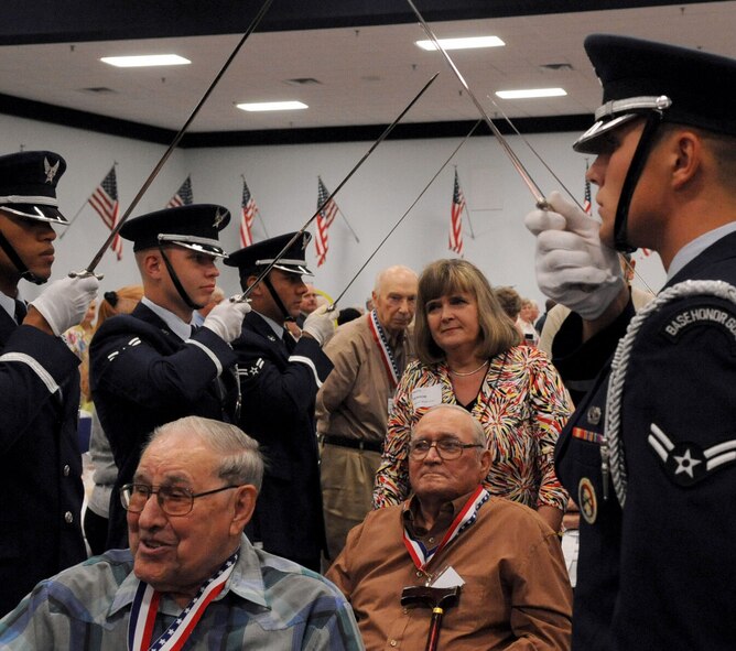 BARKSDALE AIR FORCE BASE, La. -- More than 200 World War II veterans walked through the honor guard saber arch during the Military Veterans Honors Luncheon held at Hoban Hall Aug. 27. The veterans were thanked with handshakes, hugs, smiles and words of acknowledgement from the base leadership and guests. The luncheon honored veterans from all branches of service. (U.S. Air Force photo by Senior Airman La'Shanette V. Garrett) (RELEASED)