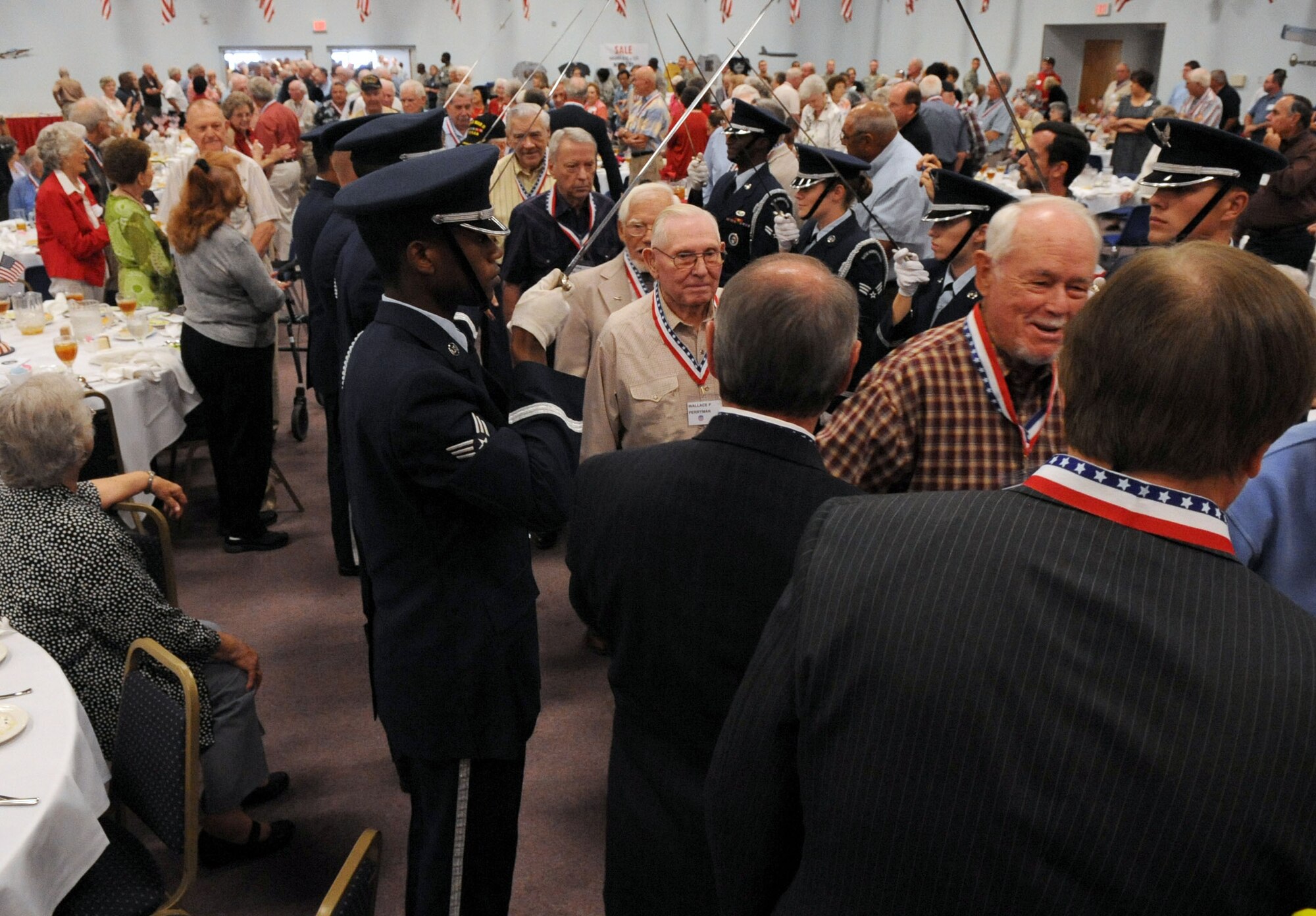 BARKSDALE AIR FORCE BASE, La. -- More than 200 World War II veterans walked through the honor guard saber arch during the Military Veterans Honors Luncheon held at Hoban Hall Aug. 27. The veterans were thanked with handshakes, hugs, smiles and words of acknowledgement from the base leadership and guests. The luncheon honored veterans from all branches of service. (U.S. Air Force photo by Senior Airman La'Shanette V. Garrett) (RELEASED)