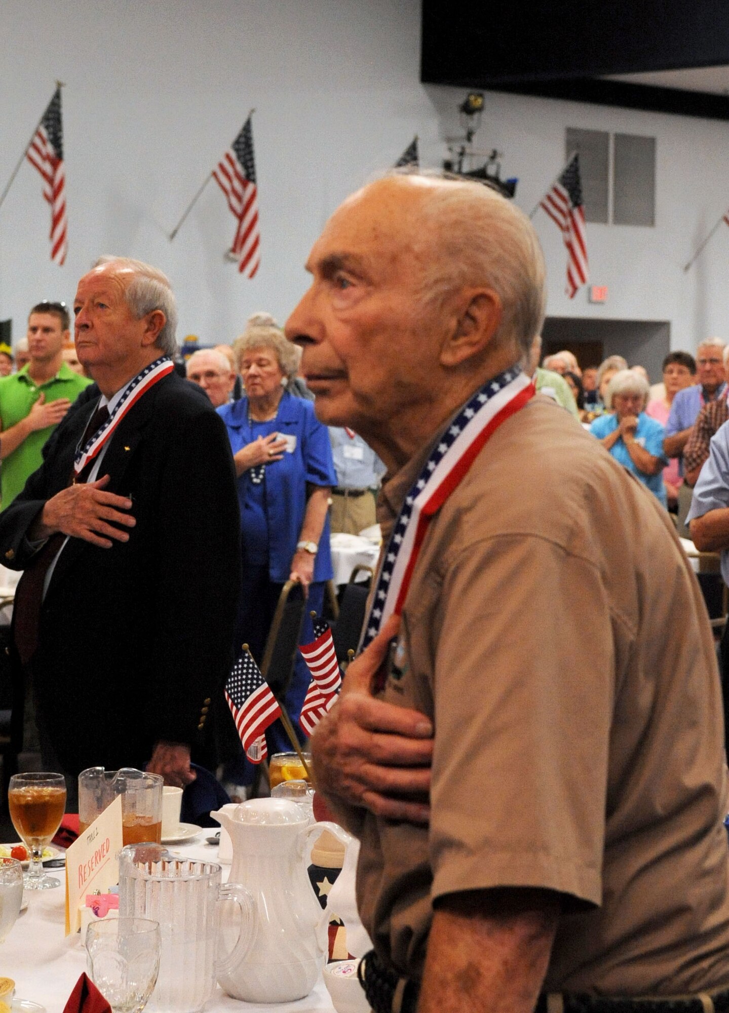 BARKSDALE AIR FORCE BASE, La. -- (Ret.) Col. Steve DePyssler, retiree office director, places his right hand over his heart during the singing of the National Anthem at the Military Veterans Honors Luncheon held at Hoban Hall Aug. 27. More than 500 veterans and guests attended the event. (U.S. Air Force photo by Senior Airman La'Shanette V. Garrett) (RELEASED)