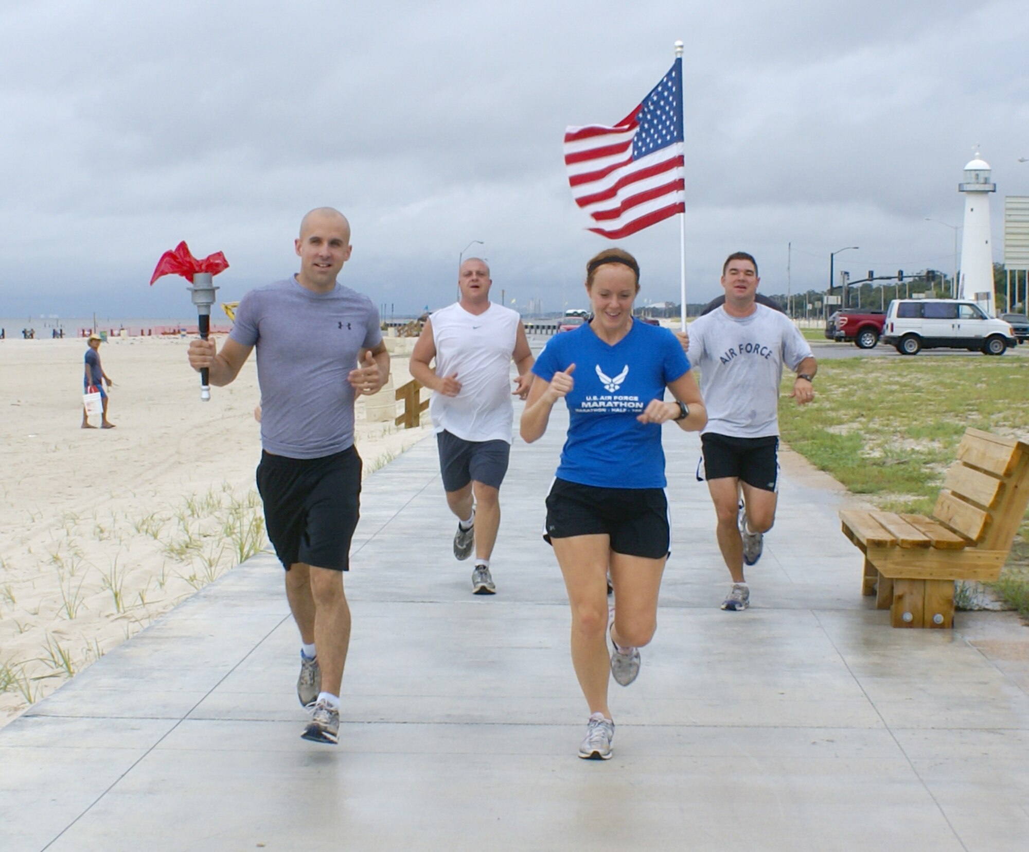 From left, Senior Airman John Westlund, Tech. Sgt. Brandin Coy, 2nd Lt. Lindsey Pope and Tech. Sgt. Tyler Hamilton from the 335th Training Squadron’s weather training flight represent Keesler in Saturday’s Katrina Torch Relay.    Airman Westlund and Lieutenant Pope are students and Sergeants Coy and Hamilton are instructors. Staff Sgts. Jonathan Berry and Daniel J. Alexander were also members of the team that carried the torch nine miles along Highway 90 from Debuys Road at the west end of Biloxi to the Isle of Capri Casino at the east edge of Biloxi.  Runners at opposite ends of the state met at the foot of the Biloxi-Ocean Springs Bridge to symbolize the unity and determination of the Mississippi Gulf Coast five years after Hurricane Katrina devastated the area.  (U.S. Air Force photo by Kemberly Groue)

