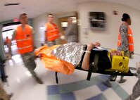 Emergency responders carry a patient into Wilford Hall Medical Center for treatment during an active shooter training exercise Aug. 31. The training exercise tested Lackland units on their ability to respond to an active shooter incident. (U.S. Air Force photo/Robbin Cresswell)