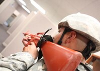 An Airman from the 802nd Security Forces Squadron clears an area of the Air Force Basic Military Training reception center during an active shooter training exercise Aug. 31. The training exercise tested Lackland units on their ability to respond to an active shooter incident. (U.S. Air Force photo/Robbin Cresswell)