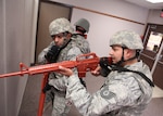 Airmen from the 802nd Security Forces Squadron clear an area of the Air Force Basic Military Training reception center during an active shooter training exercise Aug. 31. The training exercise tested Lackland units on their ability to respond to an active shooter incident. (U.S. Air Force photo/Robbin Cresswell)