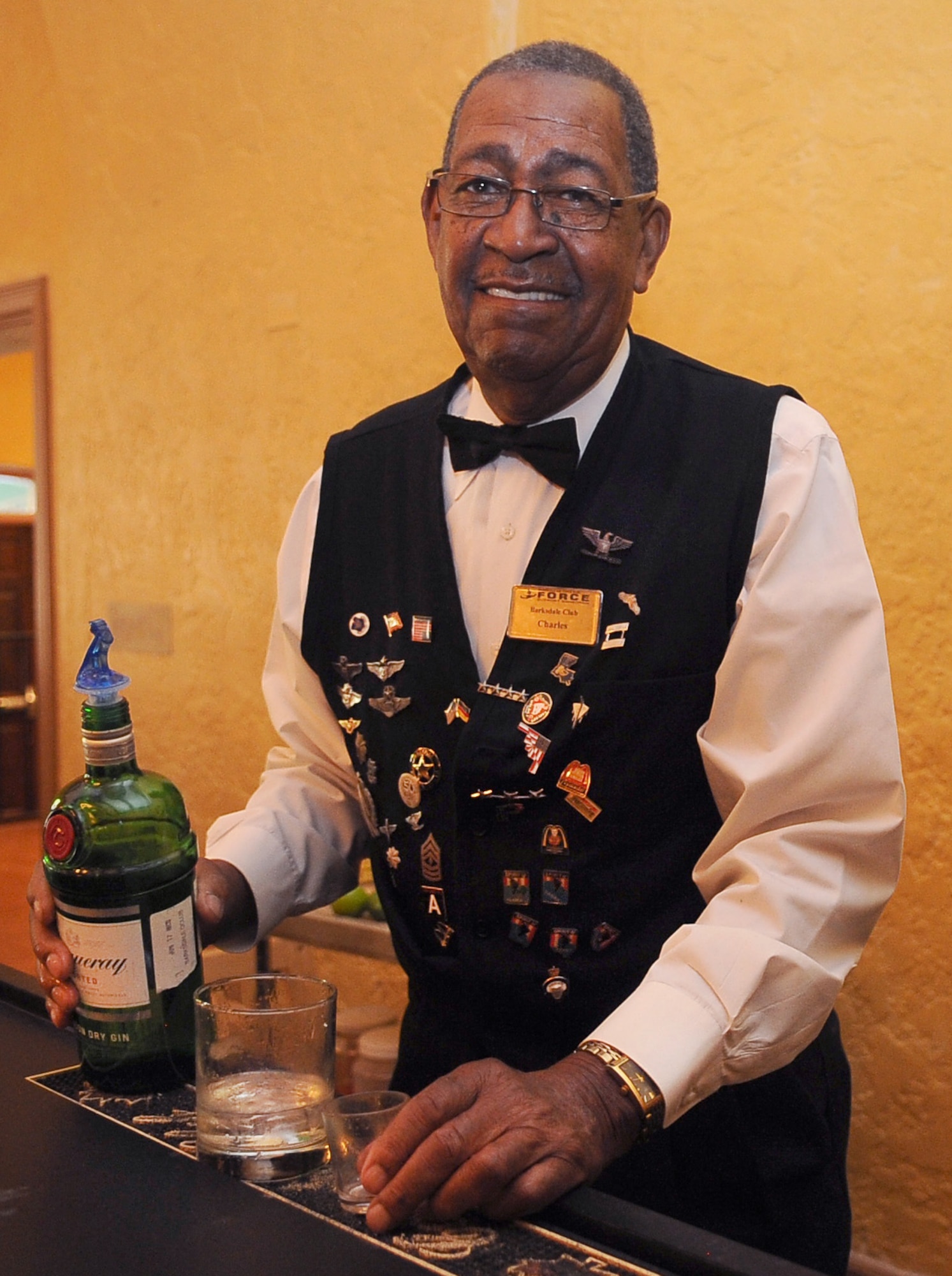 BARKSDALE AIR FORCE BASE, La. -- Charles Baker, Barksdale Officers' Club bartender, prepares a drink for a customer Aug. 27. Charles has been a part of Barksdale for more than 60 years and has met hundreds of foreign and domestic pilots and service members. Charles is famous for his long history here and his keen memory of an Airman's favorite drink. (U.S. Air Force photo/Senior Airman Amber Ashcraft) (RELEASED)