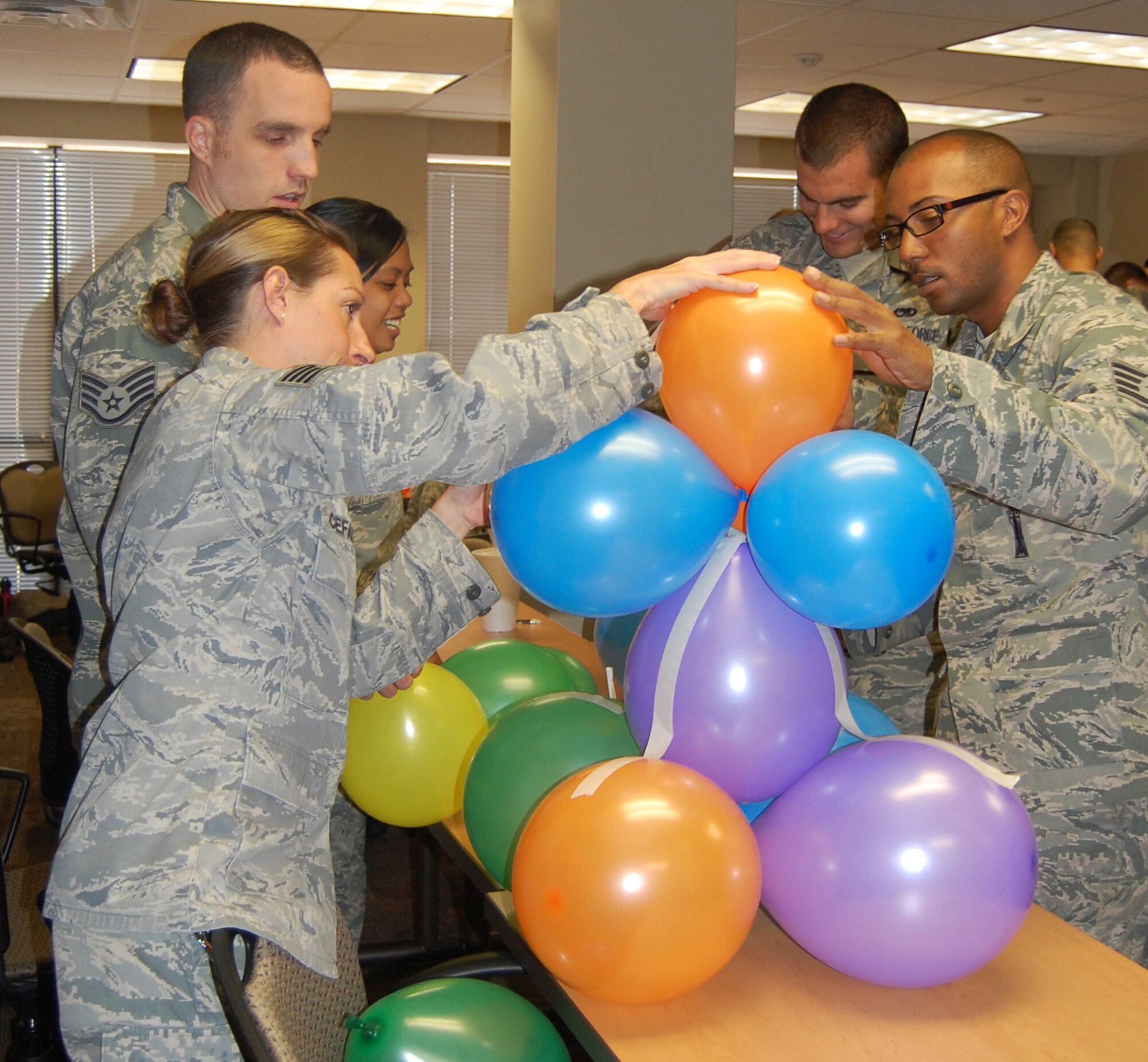 Students from the NCO Leadership Development Course build balloon towers as part of a team building exercise Aug. 20 in the 926th Group training classroom.