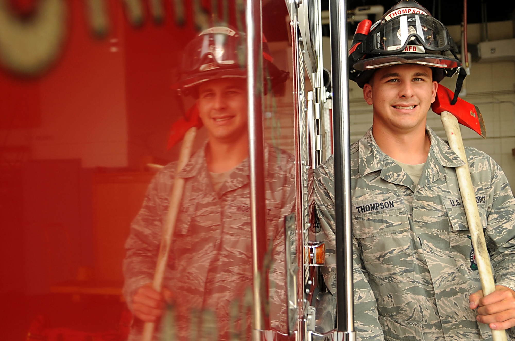 Senior Airman Joshua Thompson, 319th Civil Engineer Squadron, poses for a photo next to a fire truck Sept. 1 on Grand Forks Air Force Base, N.D. (U.S. Air Force photo by Senior Airman Amanda Stencil)