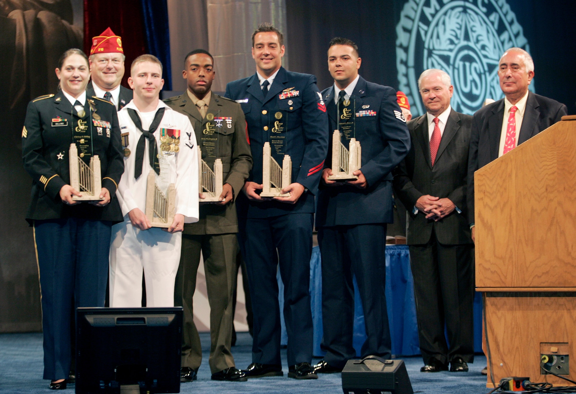 During The American Legion’s 92nd National Convention in Milwaukee, Wis., National Commander Clarence E. Hill (second from left) presented the Spirit of Service Award to Army Sgt. Chelsey D. Billing, Fort Belvoir, Va.; Navy Petty Officer 3rd Class Thomas M. Lothridge, USS Maryland, Naval Submarine Base Kings Bay, Ga.; Marine Sgt. Avery Washington II, Marine Corps Air Station Cherry Point, N.C.; Coast Guard Petty Officer 2nd Class David L. Downham, Coast Guard Air Station Atlantic City, N.J.; and Staff Sgt. Edward L. Perez, Keesler Air Force Base, Miss.  Secretary of Defense Robert Gates and actor-entertainer Ben Stein also were on hand for the presentation.  (Courtesy photo/Tom Strattman)