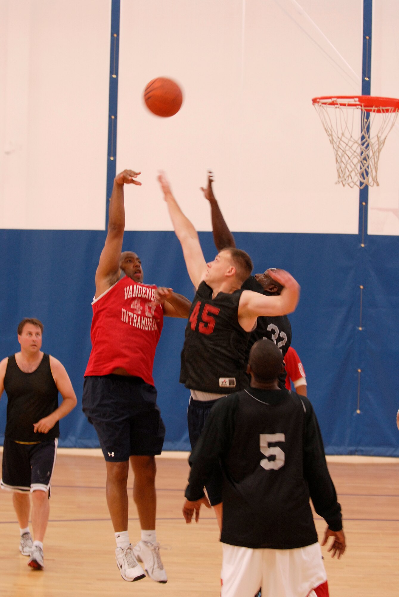 VANDENBERG AIR FORCE BASE, Calif. -- Tossing a lay-up, Lee Smith, a 30th Civil Engineer Squadron team member, throws the ball over his opponents during the over 30 intramural basketball league finals at the base fitness center here Monday, Aug. 30, 2010.  The championship game is scheduled for Thursday, Sept. 2, 2010.  (U.S. Air Force photo/Senior Airman Andrew Satran) 
