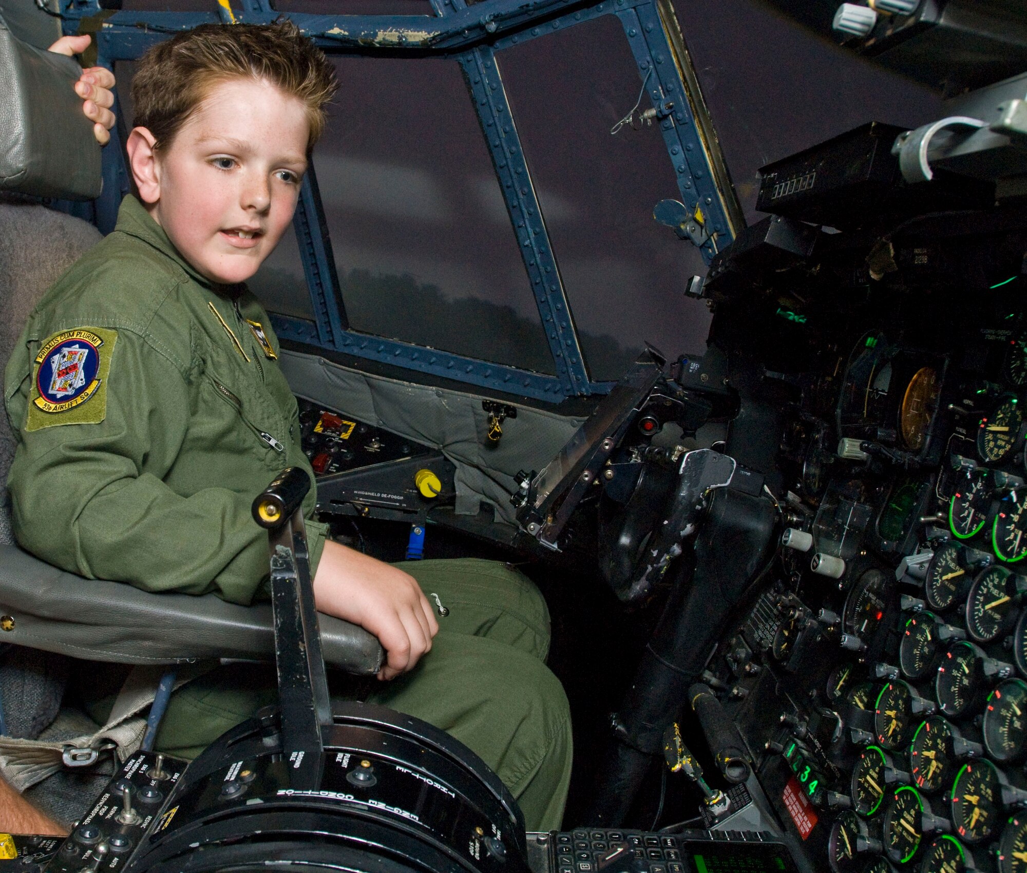 Brayden Jones straps in behind the controls of a C-130 simulator Aug. 27 at the 314th Airlift Wing’s C-130 Center of Excellence.  Four children undergoing care at the Arkansas Children’s Hospital for various illnesses were given the opportunity to become “Pilots for a Day,” experiencing different aspects of life within the Air Force. (U.S. Air Force photo by Staff Sgt. Nestor Cruz)