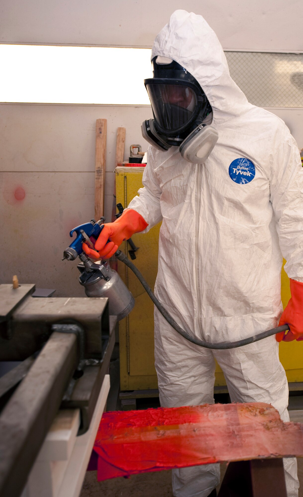 HOLLOMAN AIR FORCE BASE, N.M. -- Ruben Elizaldez, 846th Test Squadron corrosion control specialist, uses a spray gun, July 16, 2010, to paint a sign that will be displayed at the 846th Test Squadron Sled Park. Mr. Elizaldez and other corrosion control specialists are responsible for repainting the sleds used in the park to bring them back to their original state. The 49th Civil Engineer Squadron's Engineering Flight, Environmental Flight and Fire Protection Flight also assisted in making the Sled Park a reality. (U.S. Air Force photo by Senior Airman Sondra Escutia)