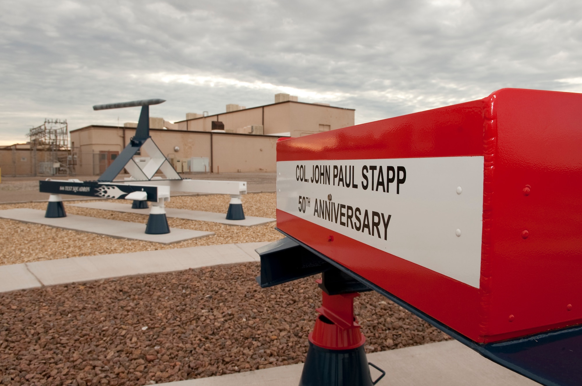 HOLLOMAN AIR FORCE BASE, N.M. -- A commemorative 50th Anniversary replica sled of "The Fastest Man On Earth," Col. John Paul Stapp, is displayed at the 846th Test Squadron Sled Park July 16, 2010. In 1954, Colonel Stapp rode on the Holloman High Speed Test Track at 632 miles per hour, and came to a dead stop in 1.4 seconds. He was subjected to more than 40 times the pull of gravity proving that this kind of deceleration could be survived. The 50th Anniversary commemorative sled was designed to replicate the sled Colonel Stapp rode in the original ride -- the "Sonic Wind." (U.S. Air Force photo by Senior Airman Sondra Escutia)