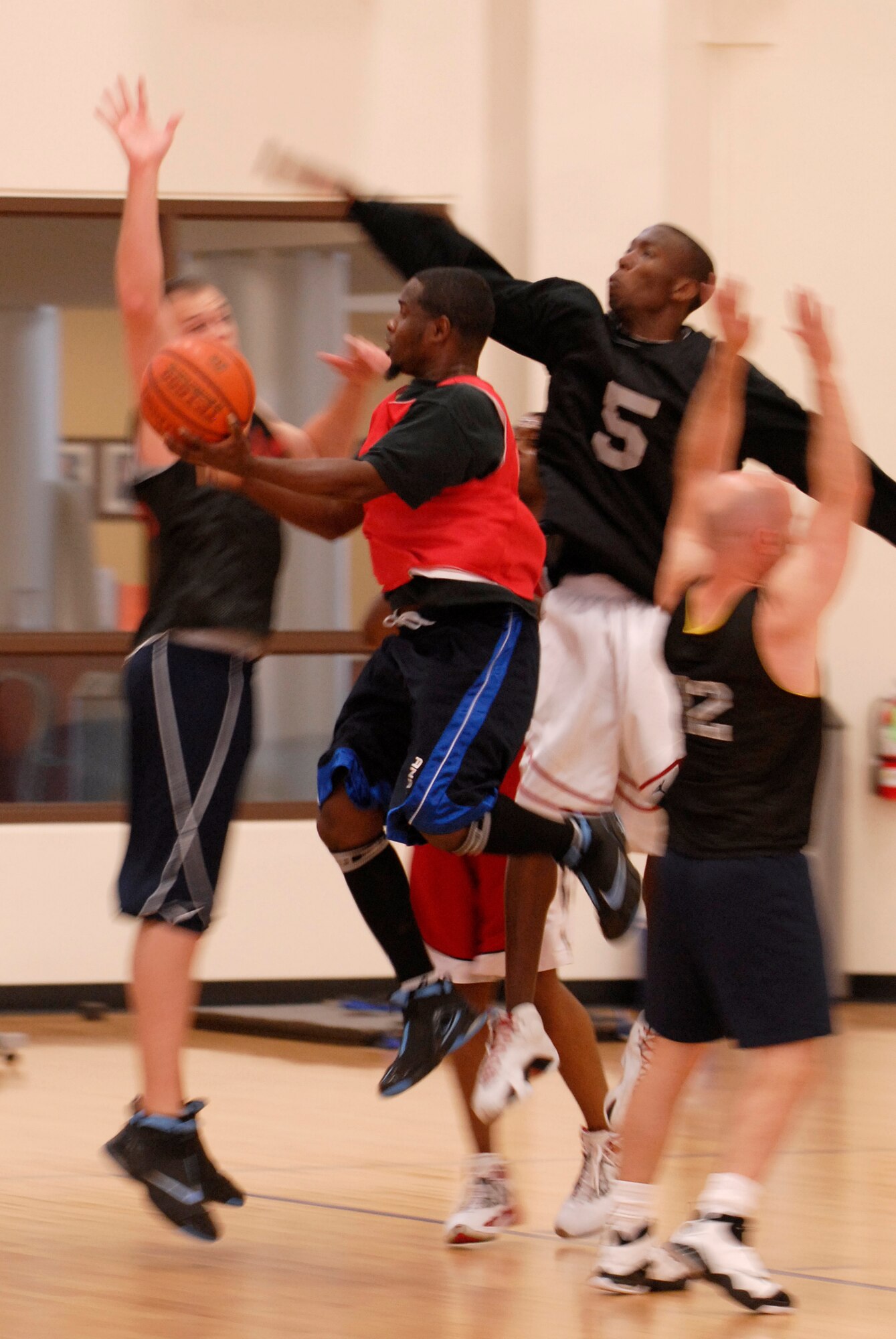 VANDENBERG AIR FORCE BASE, Calif. -- Pushing through his opponents, Rod Denson, a 30th Civil Engineer Squadron team member, leaps to throw a lay-up during the over 30 intramural basketball league finals at the base fitness center here Monday, Aug. 30, 2010.  The 30th LCG team play in the championship game against the 30th CES team on September 2nd, 2010.  (U.S. Air Force photo/Senior Airman Andrew Satran) 

 
 
 

 