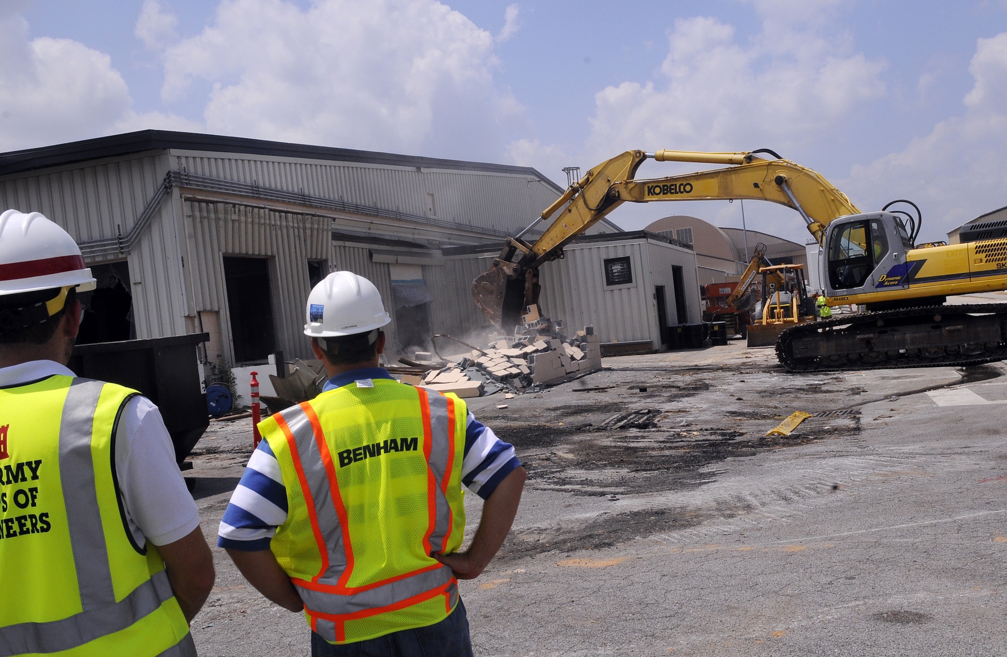People involved with the construction project watch part of the demolition of Bldg. 148 to make room for the new Advanced Metal Finishing Facility. U. S. Air Force photo by Sue Sapp